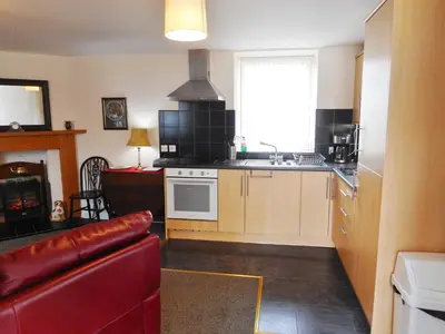 a kitchen with a sink and a stove top oven at DairyCottage, 5, TELFORD MEWS BEATTOCK in Moffat