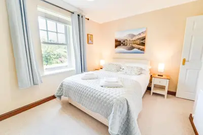 a bedroom with a bed and a window at Briarwood House in Keswick