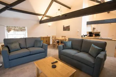 a living room with two couches and a table at Netherby Hall in Carlisle