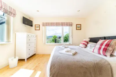 a bedroom with a bed and a window at Borrowdale View in Keswick