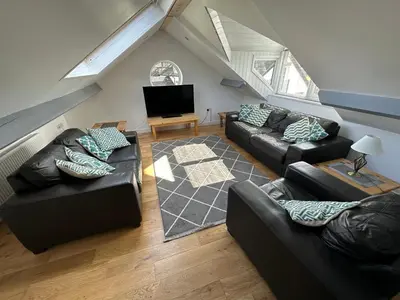 a living room with two couches and a tv at Borrowdale View in Keswick