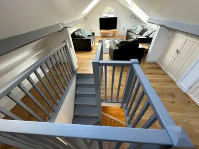 a stairway leading up to a living room at Borrowdale View in Keswick