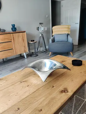 a living room with a wooden table with a bowl on it at Anchors Away in Ayr