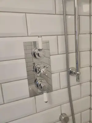 a shower in a bathroom with white tiles at Anchors Away in Ayr