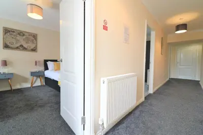 a room with a door leading to a bedroom at Signature - Kirkhill House in Kirkmuirhill