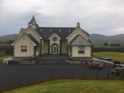 a large house with a table in front of it at Cumnock Knowes Holiday Retreat in Carsphairn