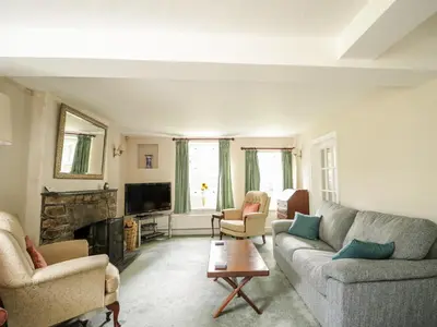 a living room with two couches and a fireplace at Fell Foot in Holmrook