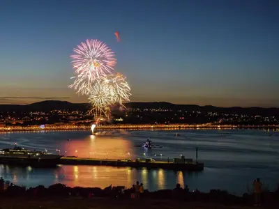 a firework display on the water at night at Cunard Apartments in Douglas