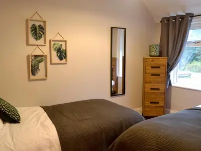 a bedroom with a bed and a mirror and a dresser at Terraughtie Cottage East-Uk31767 in Terreglestown