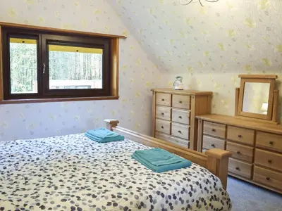 a bedroom with a bed and a window at Glen Rosa in Ayr