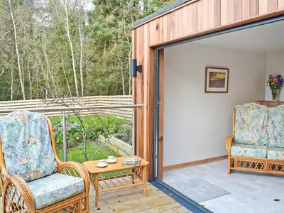 a room with a patio with two chairs and a table at Glen Rosa in Ayr
