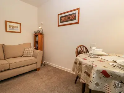 a living room with a table and a couch at Oak View in Keswick