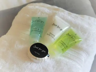 a group of three beauty products sitting on a towel at Garrarie Cottage in Monreith