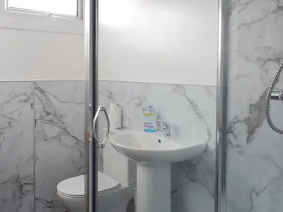 a white bathroom with a sink and a toilet at West Lodge - Uk7137 in Newton Stewart