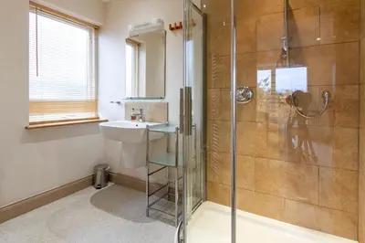 a bathroom with a shower and a sink at The Lookout Keswick in Keswick