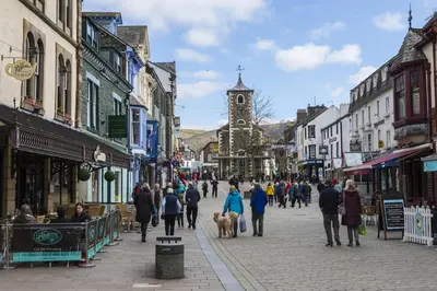 a group of people walking down a city street at The Lookout Keswick in Keswick
