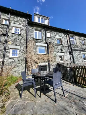 a table and chairs in front of a building at Meadow View Chapel Stile in Chapel Stile