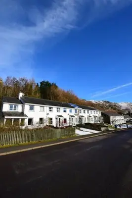 a white house on the side of a street at 12 Thrang Brow, Chapel Stile in Chapel Stile