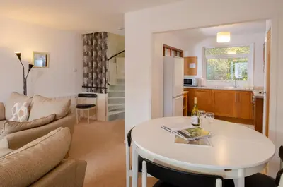 a living room and kitchen with a table and a couch at 12 Thrang Brow, Chapel Stile in Chapel Stile