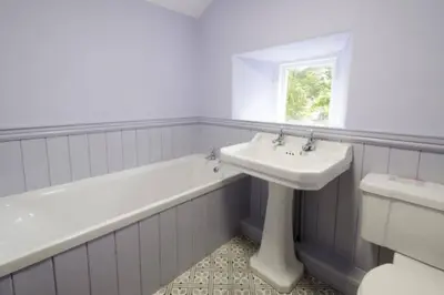 a bathroom with a sink and a bath tub and a toilet at Beck Steps, Elterwater in Chapel Stile