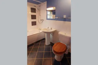 a bathroom with a toilet and a sink and a tub at Church Bank in Chapel Stile