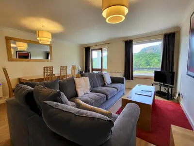 a living room with a couch and a table at Lingmell Fell View, Chapel Stile in Chapel Stile