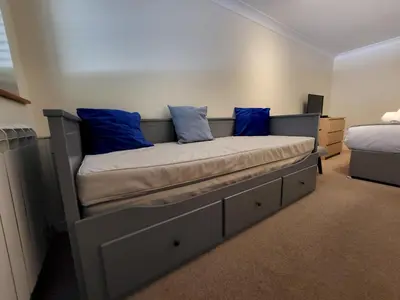 a bed in a room with blue pillows on it at Lingmell Fell View, Chapel Stile in Chapel Stile
