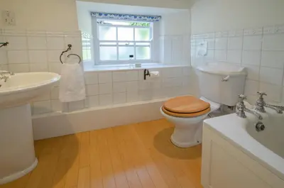 a bathroom with a toilet and a sink and a tub at Priest End, Chapel Stile in Chapel Stile