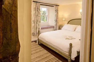 a small bedroom with a bed and a window at Speddy Cottage, Chapel Stile in Chapel Stile