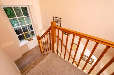 a staircase in a house with a window at The Old White Lion, Chapel Stile in Chapel Stile