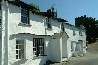 a couple of white houses sitting on a street at The Old White Lion, Chapel Stile in Chapel Stile
