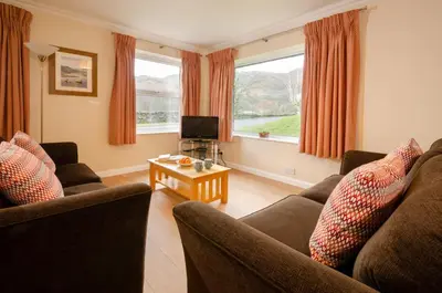 a living room with two couches and a television at Underthrang, Chapel Stile in Chapel Stile