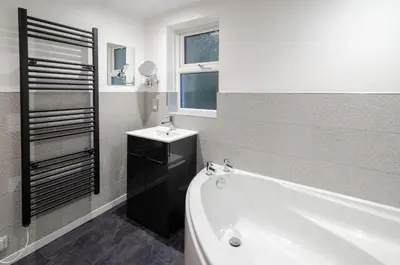 a bathroom with a tub and a sink and a bath tub at Underthrang, Chapel Stile in Chapel Stile