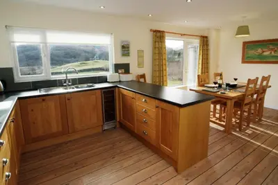 a kitchen with a counter top and a dining room at Lang Parrock, Little Langdale in Little Langdale