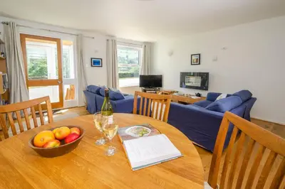 a living room with a table with a bowl of fruit at Jadians Nook, 16 Thrang Brow in Chapel Stile