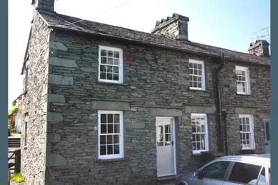 an old stone house with a car parked in front at Victory Cottage - Victory Cottage, Cosy village retreat in Chapel Stile
