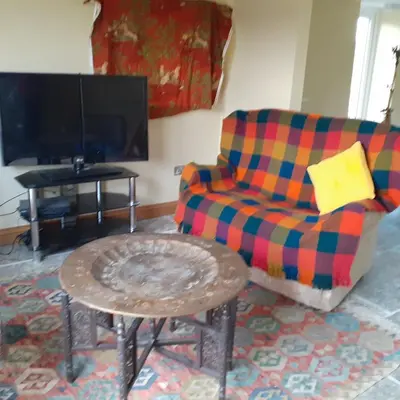 a living room with a couch and a coffee table at Cottage at Inch Farm solitude beside the River in Longtown