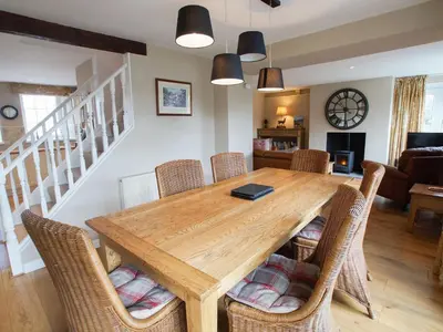 a dining room with a wooden table and chairs at Plumblands in Ambleside