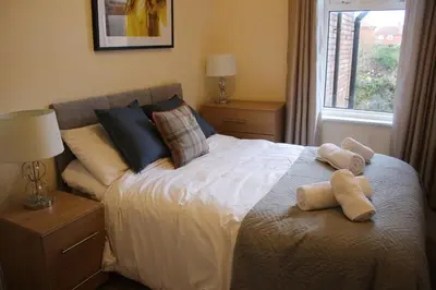 a bedroom with a bed with two teddy bears on it at Carvetii - Quentin House - Near Hospital, max 7 ppl in Carlisle