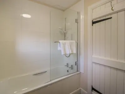 a white bathroom with a shower and a tub at Ardlochan Lodge - Culzean Castle in Maybole