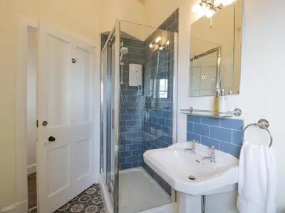a bathroom with a sink and a shower at Brewhouse Flat - Culzean Castle in Maybole