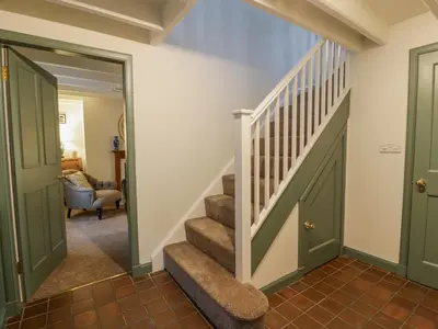 a staircase in a home with green doors at Blue Door - Kirkcudbright in Kirkcudbright