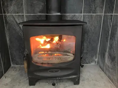a black stove with a fire in it at The Annex in Carlisle