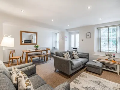 a living room with a couch and a table at The Plosh in Keswick