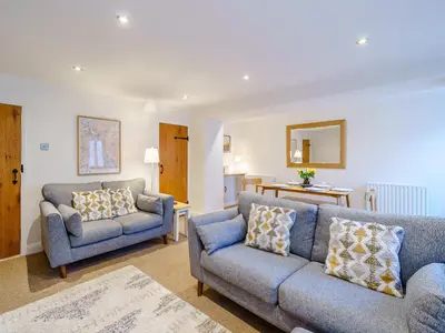 a living room with two chairs and a couch at The Plosh in Keswick