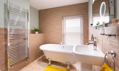 a bathroom with a tub and a sink and a shower at Dovedale in Keswick