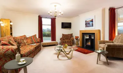 a living room with a couch and a fireplace at One The Howe in Portinscale