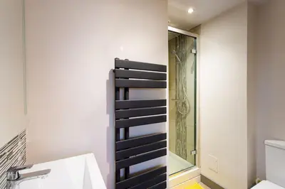 a bathroom with a shower and a sink at Sunnybank Cottage in Keswick