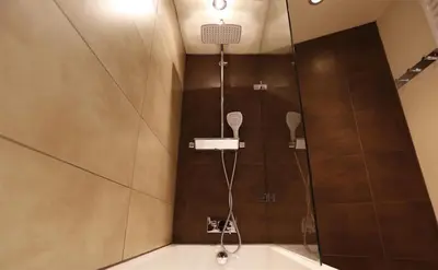 a shower with a glass door in a bathroom at Townfoot Cottage in Elterwater
