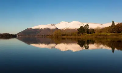 a large body of water with a mountain in the background at Grange Fell Borrowdale in Keswick